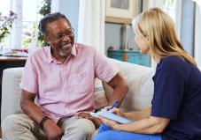 elder man ang caregiver talking