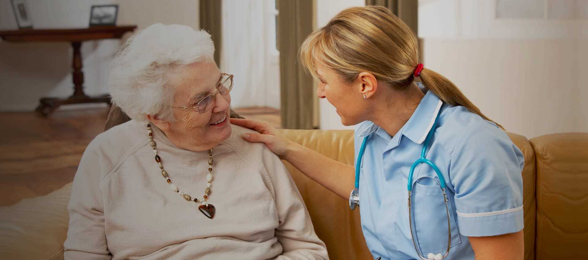 nurse talking to an elder woman